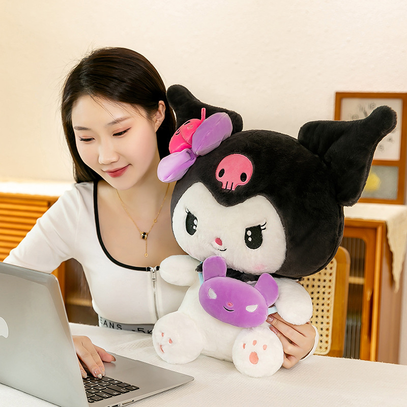 Kuromi plush toy with a mini crossbody bag beside a laptop, providing a cozy companion for studying, working, or relaxing at your desk
