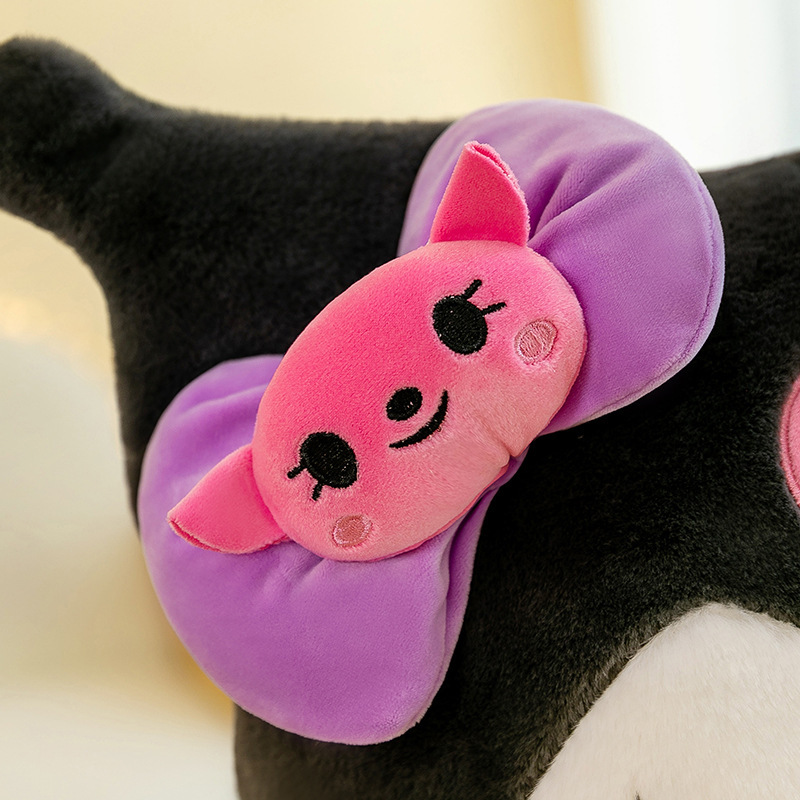 Close-up of Kuromi plush toy featuring a purple bow with a cute pink character detail, showcasing soft plush fabric and embroidered accents