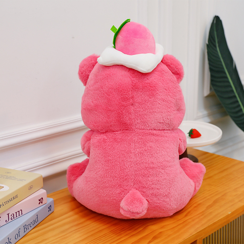 Back view of the Pink Bear Plush Toy in Strawberry Cake style, showcasing the soft plush fabric, rounded shape, small tail, and strawberry hat detail