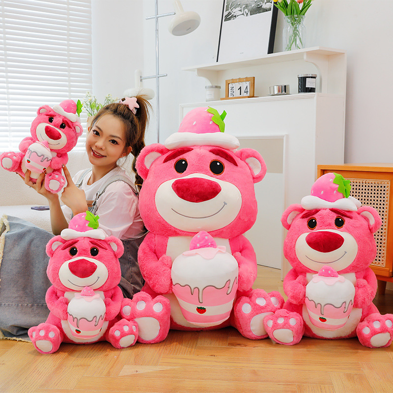 Pink Bear Plush Toy in Strawberry Cake style displayed in multiple sizes, featuring soft plush fabric and a strawberry cake design for decorating cozy bedrooms and living spaces
