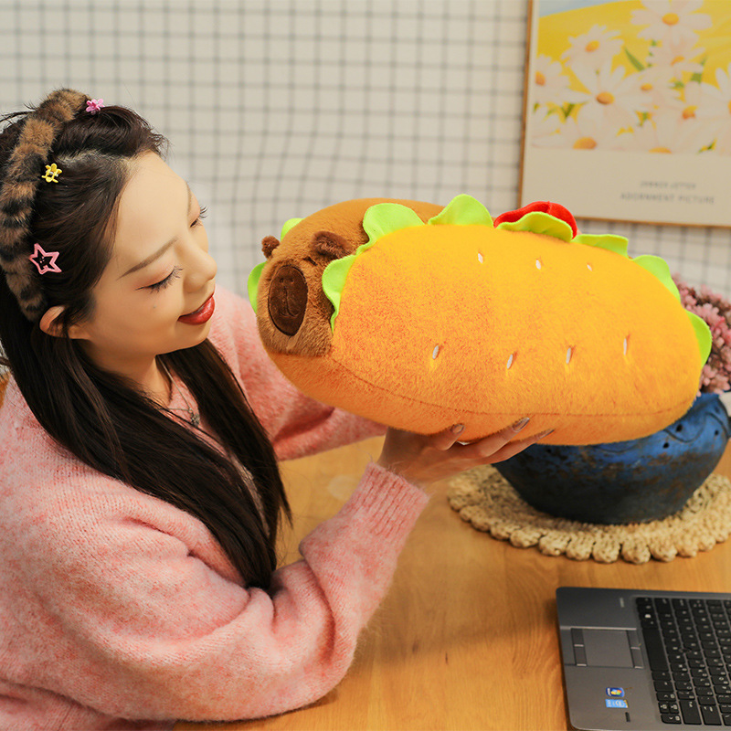 Hot Dog Capybara Plush Pillow displayed on a desk, featuring a soft plush texture and playful food-inspired design that adds warmth to cozy spaces