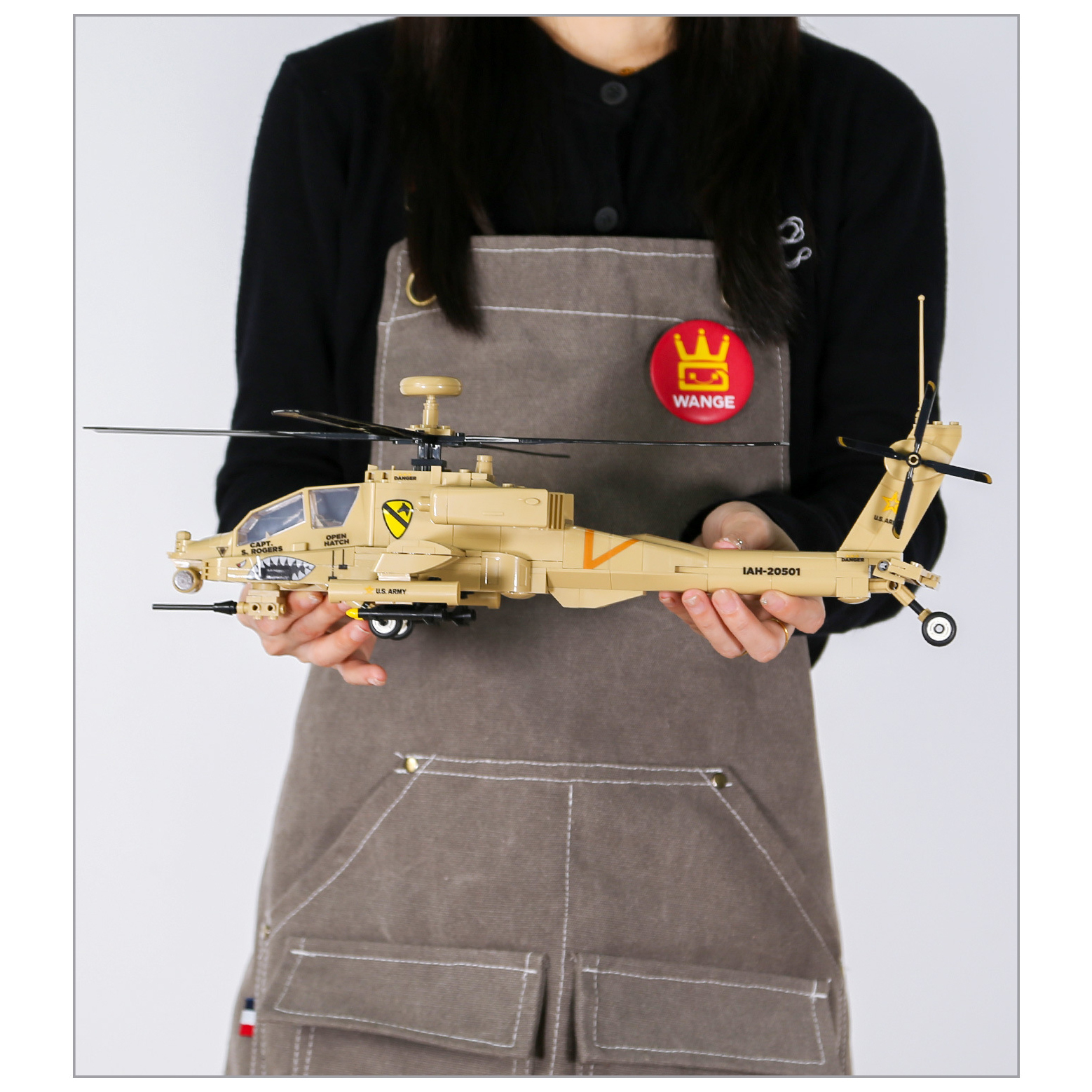 WANGE AH-64 Apache helicopter building blocks model shown for assembled size reference, featuring realistic rotor blades, cockpit, landing gear, and detailed military styling