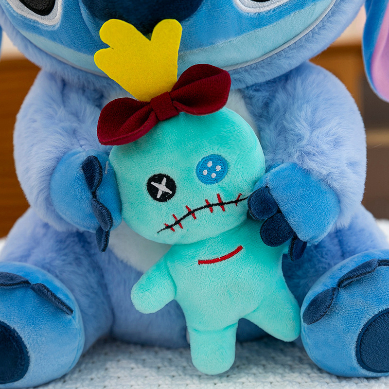 Close-up of the Stitch Costume Plush Toy holding a plush Scrump doll, showcasing embroidered details, soft plush fabric, and fluffy PP cotton filling