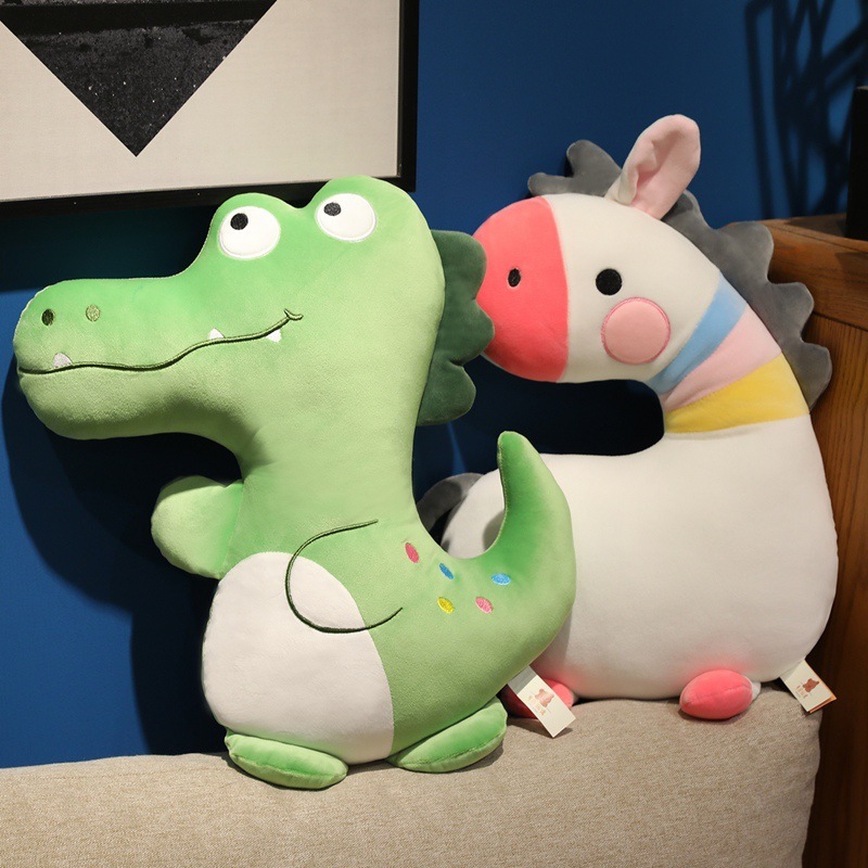 Green Crocodile and White Zebra Plush Pillows displayed together on a sofa, adding a playful touch to home decor and cozy living spaces