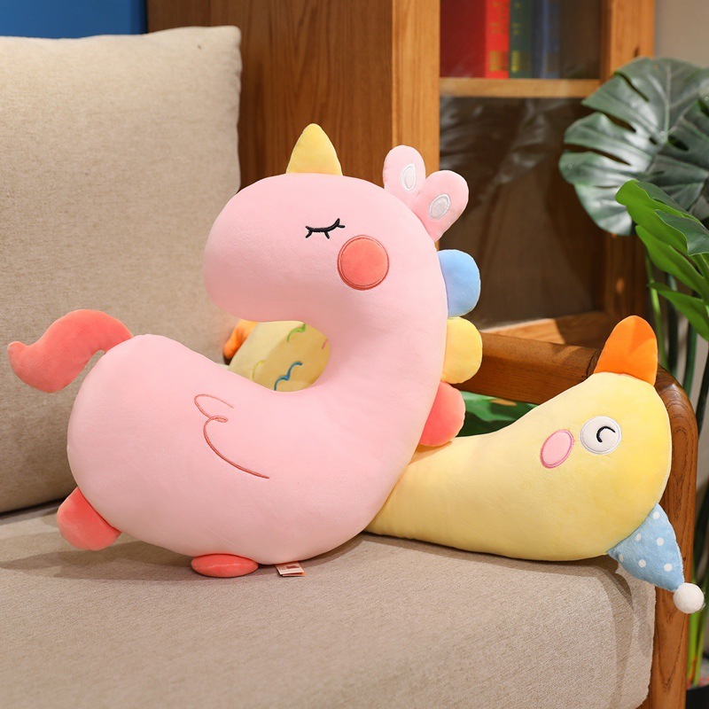 Pink Unicorn and Yellow Duck Plush Pillows displayed on a sofa, showcasing two animal designs for relaxing, decorating, and everyday comfort