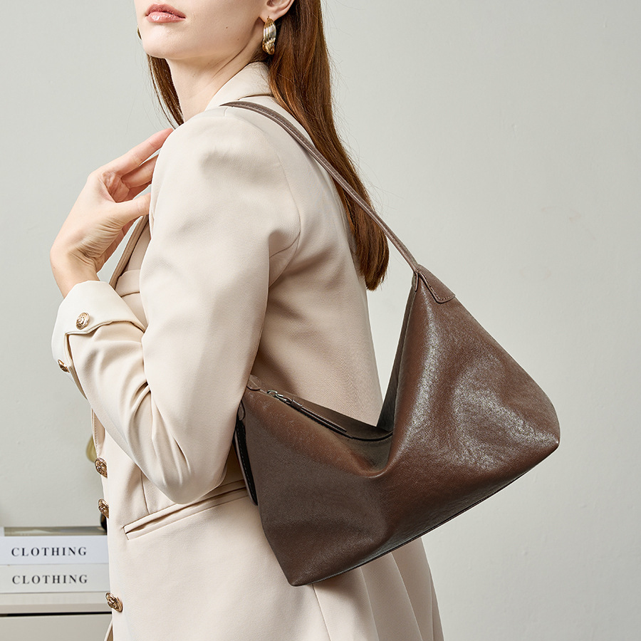Model carrying Classic Leather Hobo Bag in Baroque Brown – on shoulder