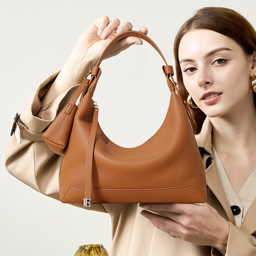 Model holding Chic Luxury Leather Hobo Bag in Golden Brown