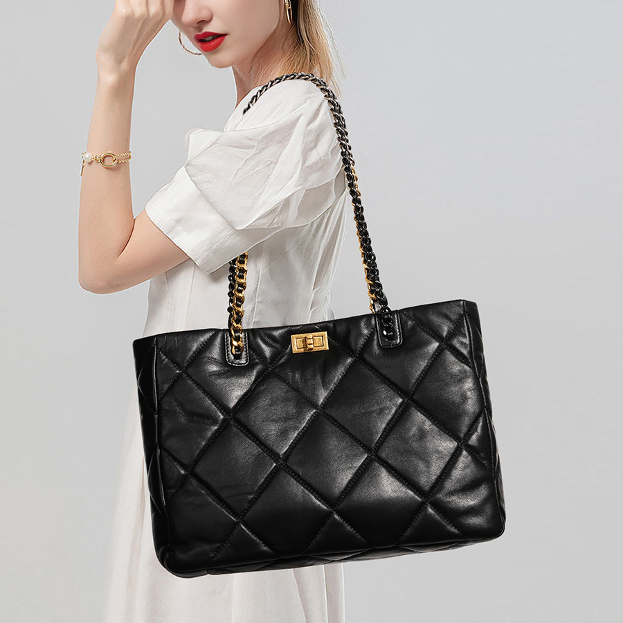 Model carrying Elegant Quilted Leather Chain Tote Bag in Black – on shoulder