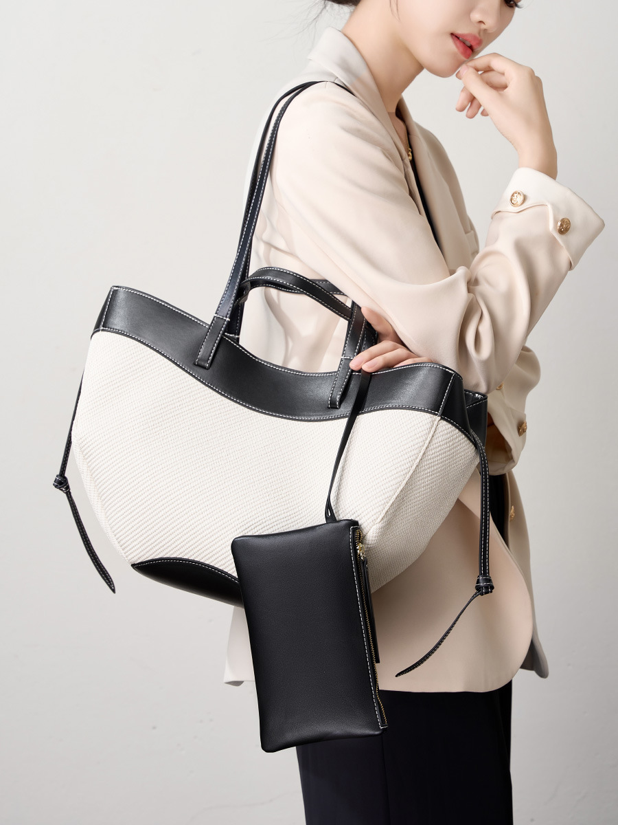 Model showcasing Wing Curve Leather Tote Bag in Black – on shoulder