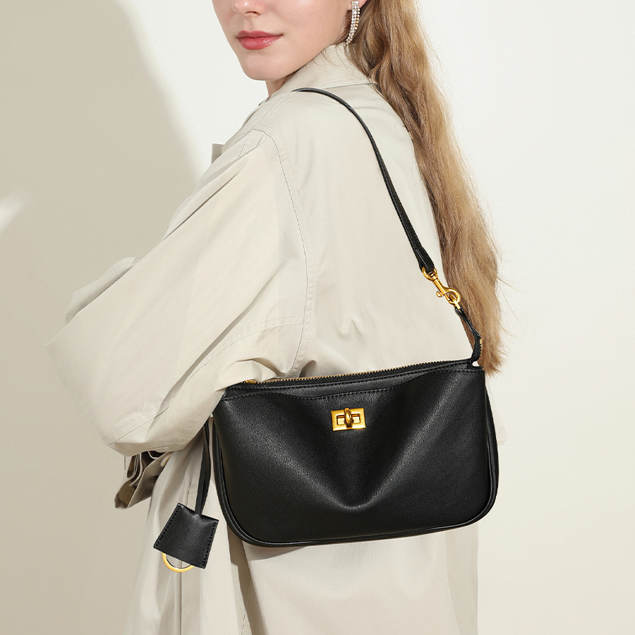 Model carrying Rodeo Leather Baguette Bag in Black – on shoulder