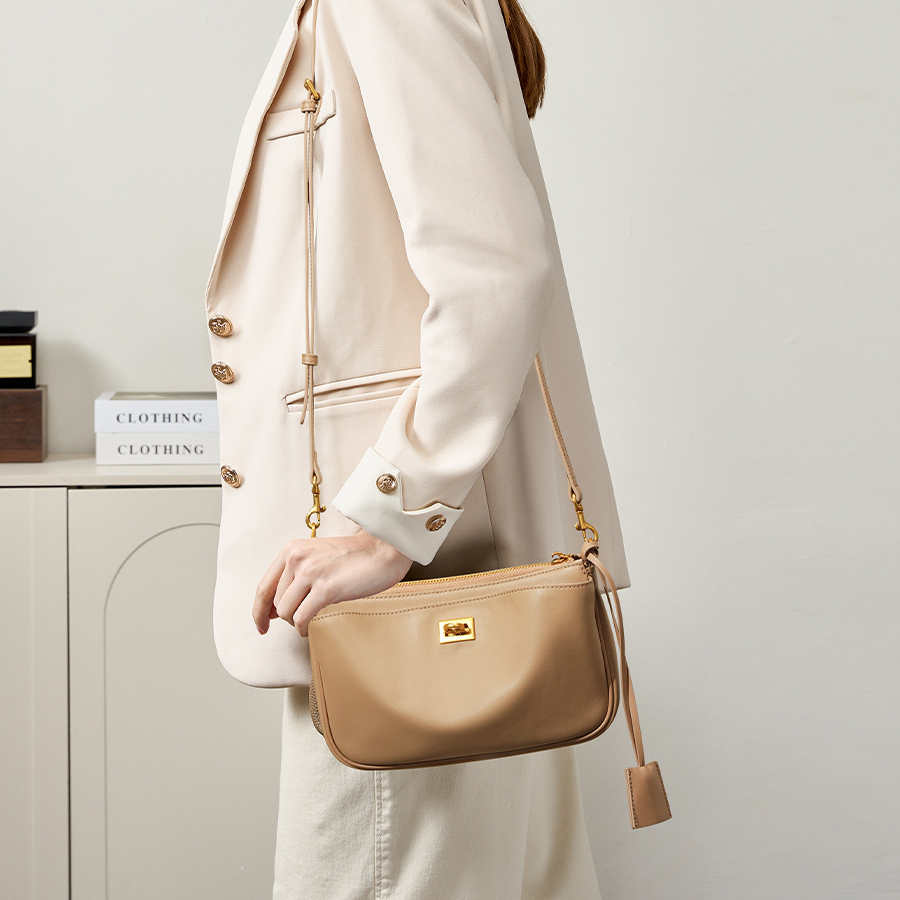 Model carrying Rodeo Leather Baguette Bag in Khaki – on shoulder