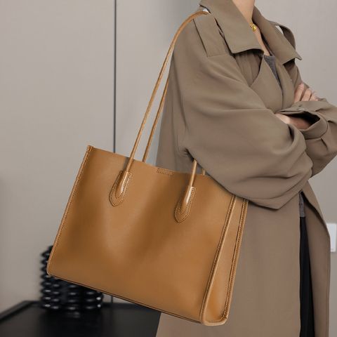 Model showcasing Premium Structured Genuine Leather Tote Bag in Golden Brown