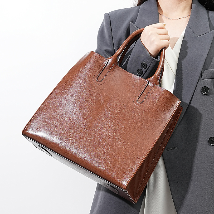Model showcasing Premium Leather Top Handle Tote Bag in Coffee