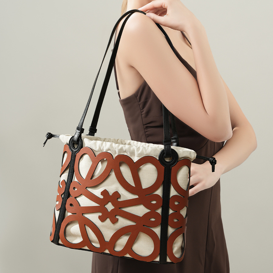 Model carrying Premium Leather Cut-Out Tote Bag in Brown – on shoulder