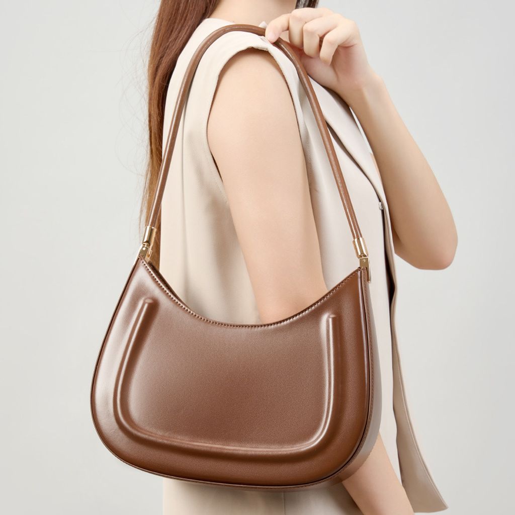 Model showcasing Oil Waxed Leather Minimalist Half Moon Bag in Caramel