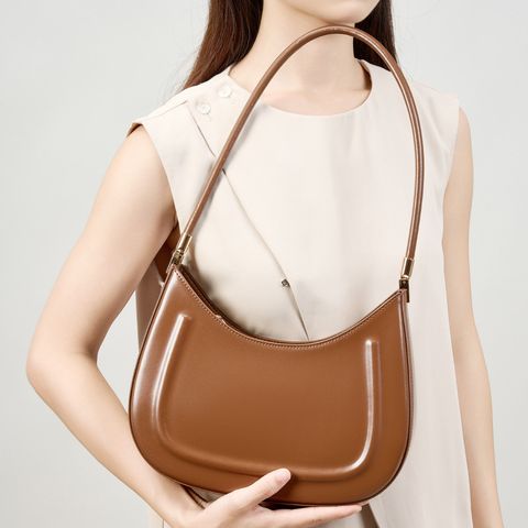 Model showcasing Oil Waxed Leather Minimalist Half Moon Bag in Caramel