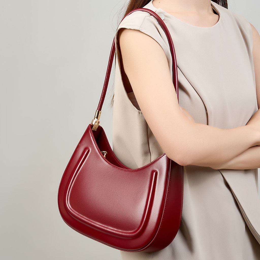 Model carrying Oil Waxed Leather Minimalist Half Moon Bag in Burgundy – on shoulder