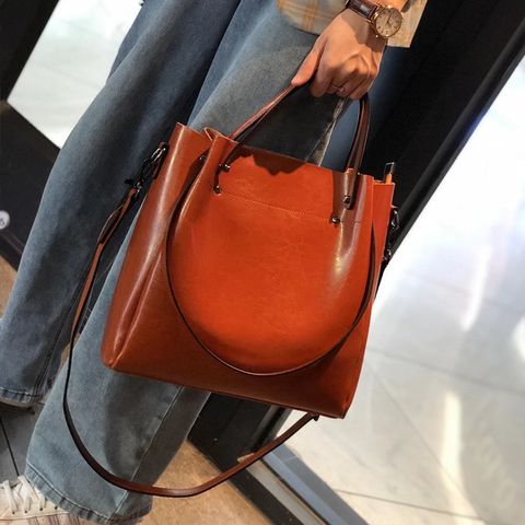 Model showcasing Elegant Oil Waxed Leather Top Handle Tote Bag in Caramel