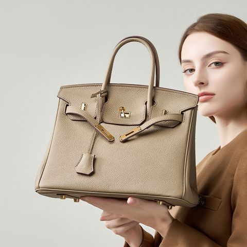 Model showcasing Premium Togo Leather Structured Top Handle Bag in Khaki
