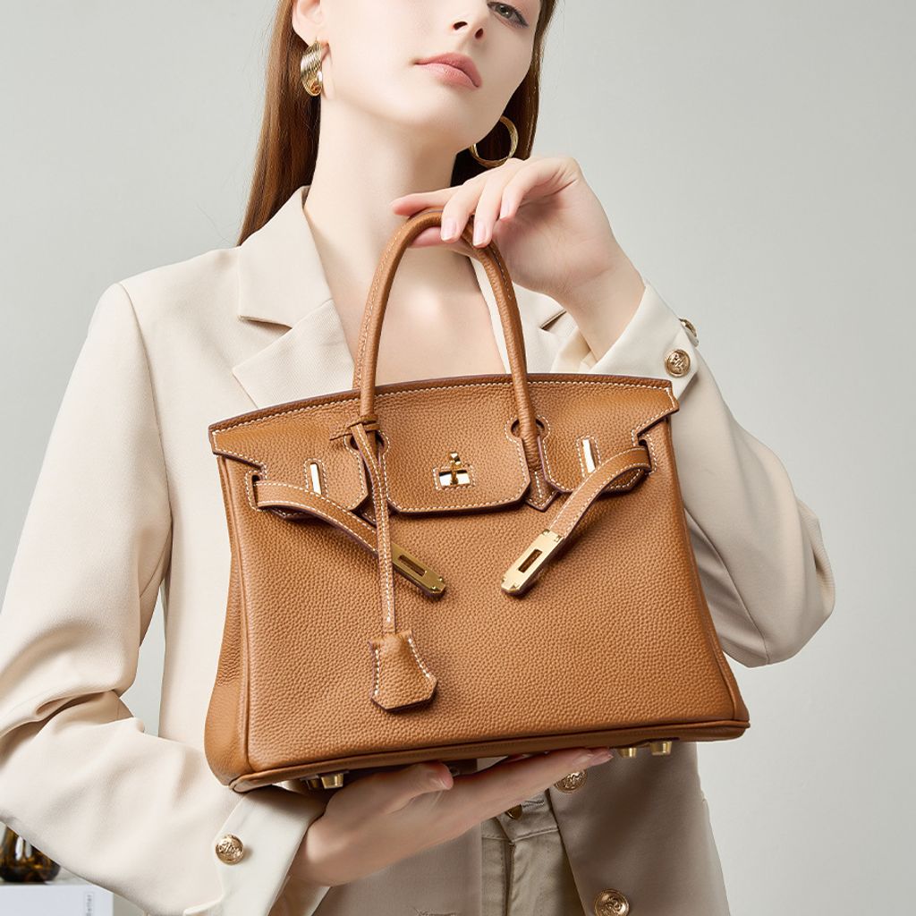 Model showcasing Premium Togo Leather Structured Top Handle Bag in Golden Brown