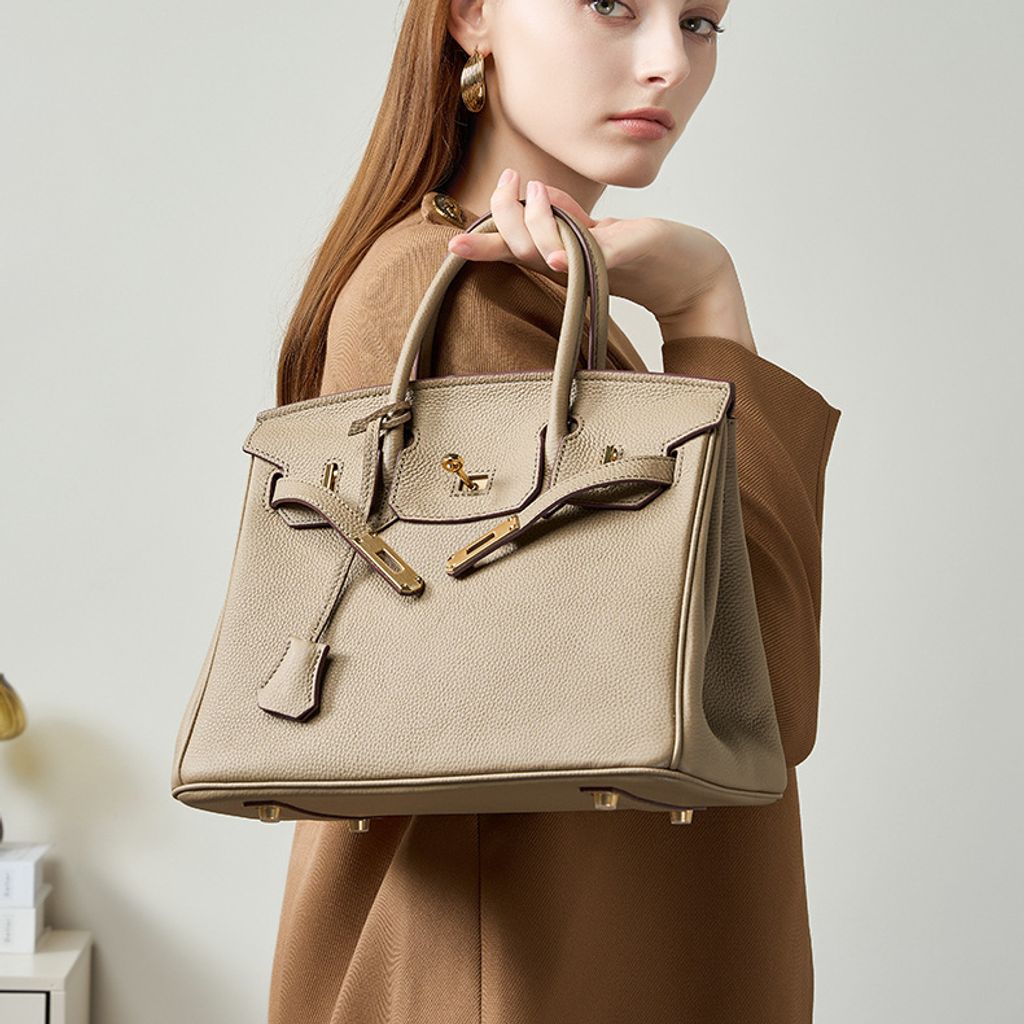 Model showcasing Premium Togo Leather Structured Top Handle Bag in Khaki
