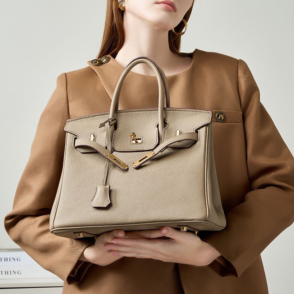 Model showcasing Premium Togo Leather Structured Top Handle Bag in Khaki
