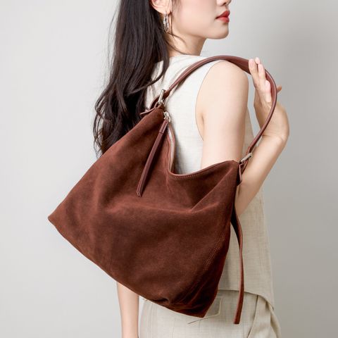 Model carrying Genuine Matte Suede Leather Hobo Bag in Coffee on Shoulder