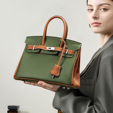 Model with Premium Togo Leather Structured Two-Tone Top Handle Bag