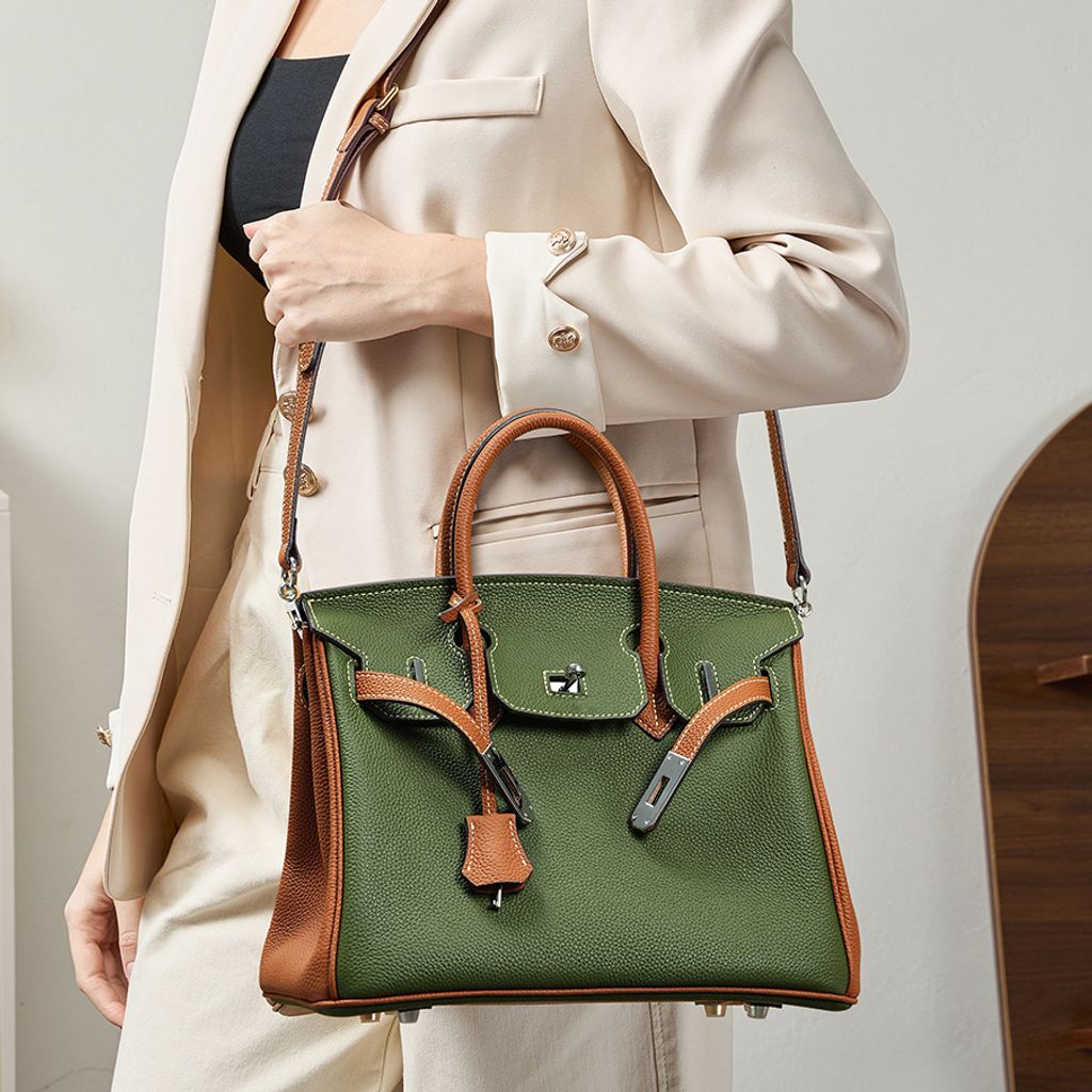 Model carrying Premium Togo Leather Structured Two-Tone Top Handle Bag on shoulder