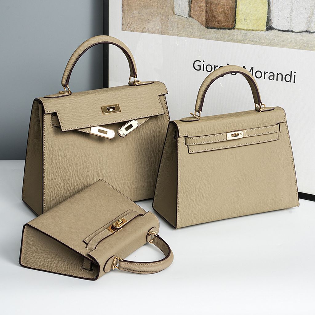 Lifestyle shot of Premium Genuine Leather Structured Top Handle Bags in Elephant Gray, shown in three different sizes