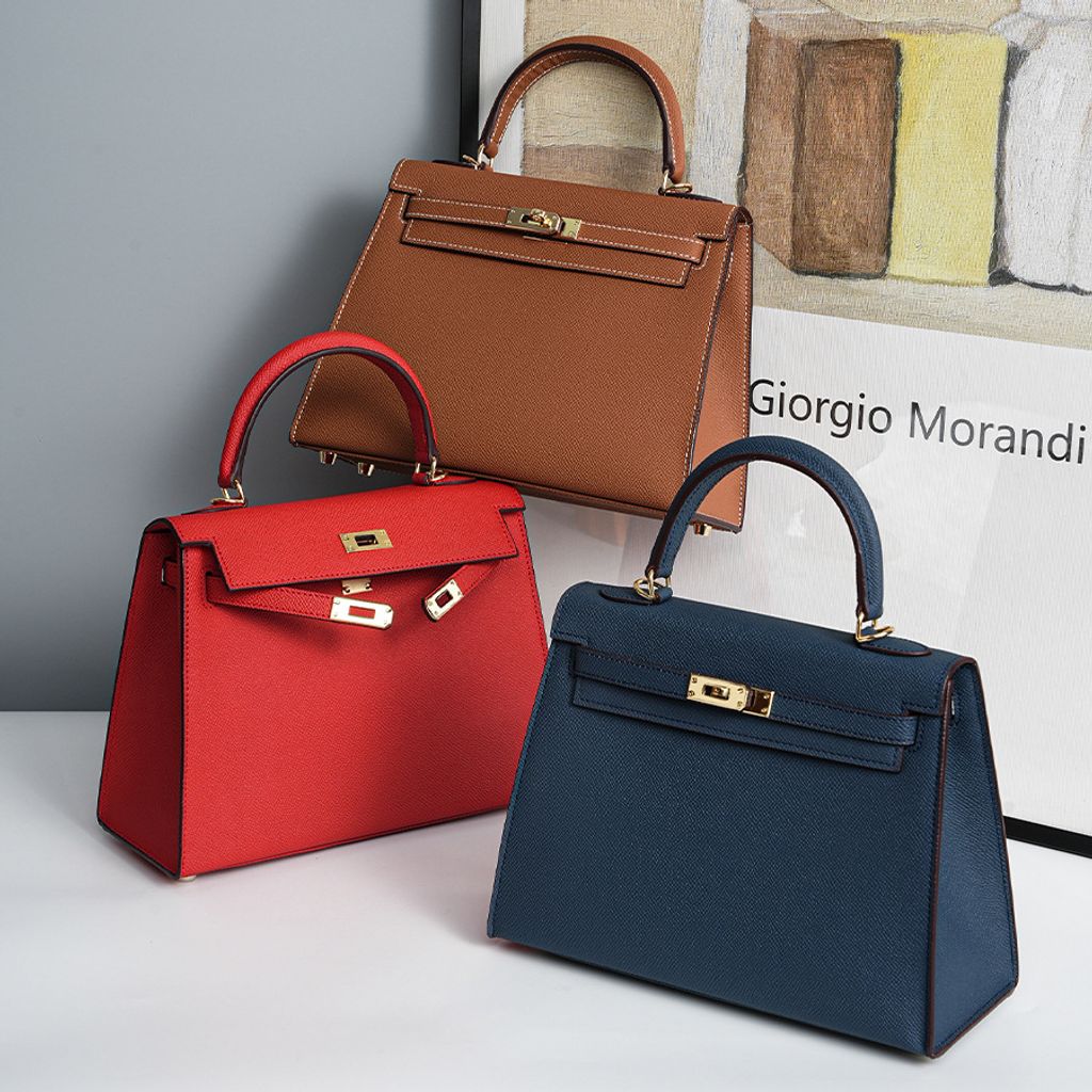 Lifestyle shot of Premium Genuine Leather Structured Top Handle Bags in Royal Blue, Bright Red, and Golden Brown