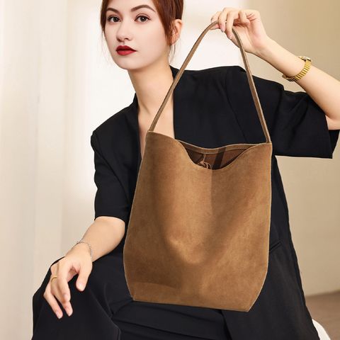 Model showcasing the Refined Suede Leather Bucket Tote Bag in Caramel (Large Size)