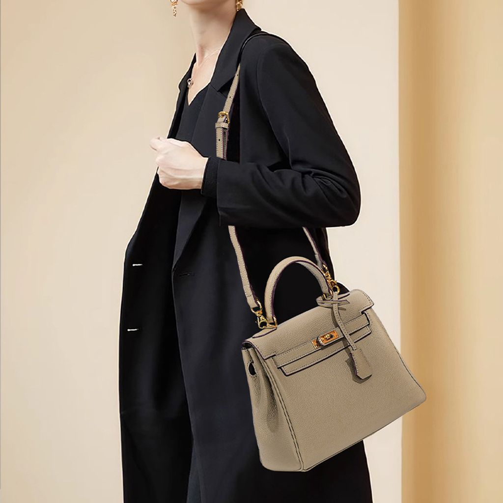 Model carrying Premium Togo Leather Structured Top Handle Bag in Khaki