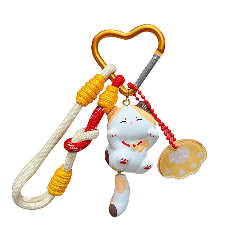 Calico cat keychain charm on white background