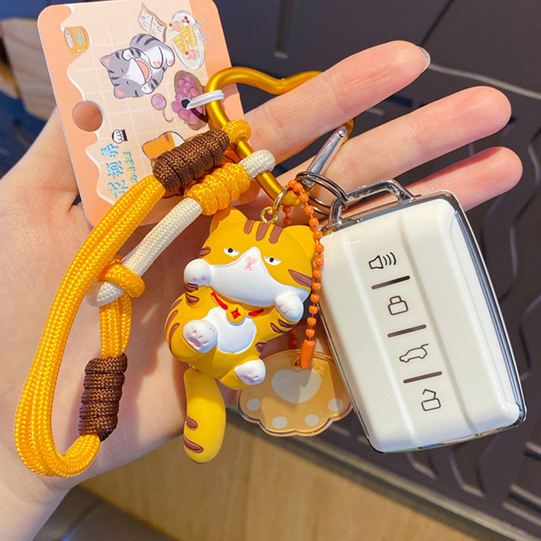 Orange cat keychain charm attached to a car key fob
