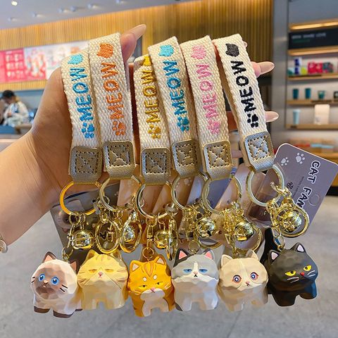 Cute cat family wood carving style keychain charms showing all six designs