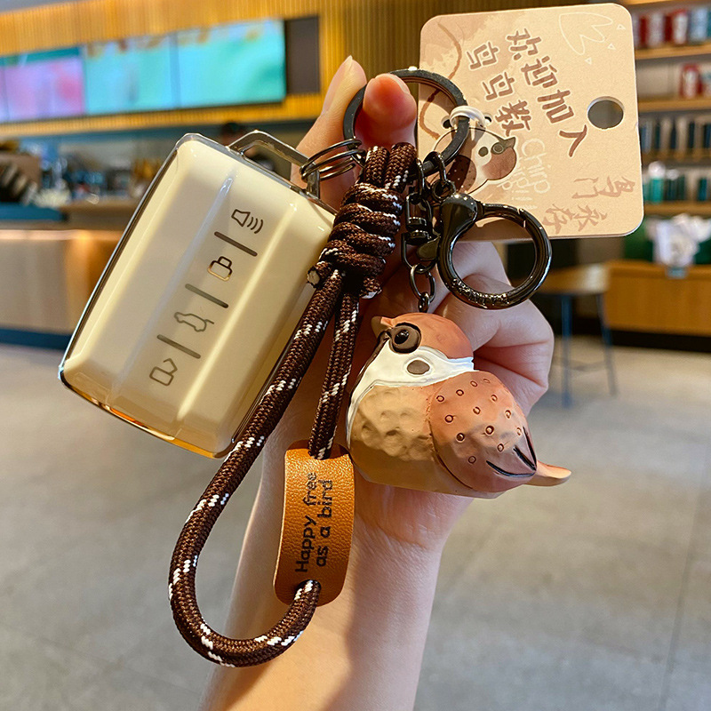Tree sparrow keychain charm attached to a car key fob