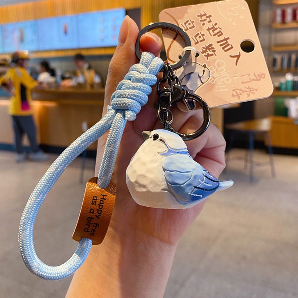 Cute chirpy bird wood carving style keychain charm gray-blue mountain bird variant