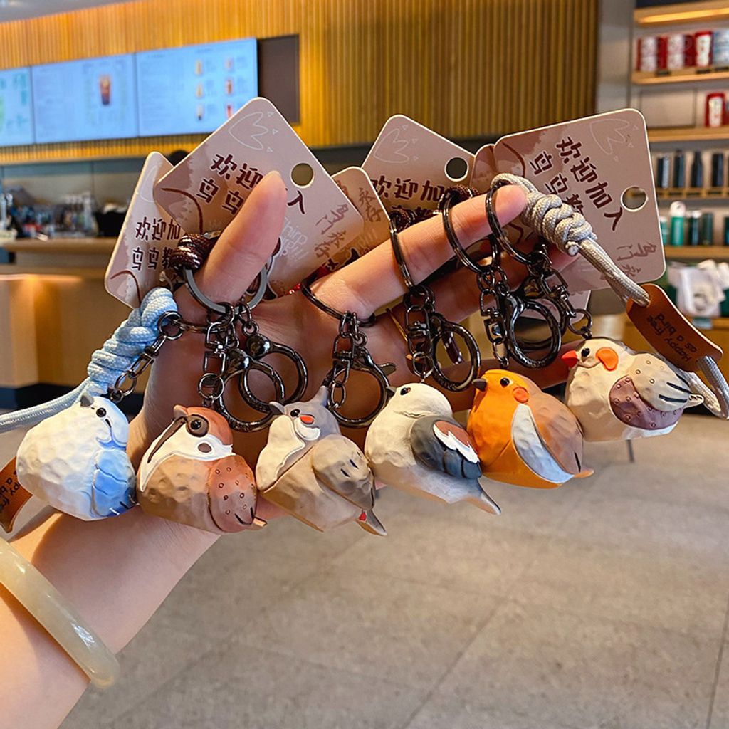 Cute chirpy bird wood carving style keychain charms showing all six designs