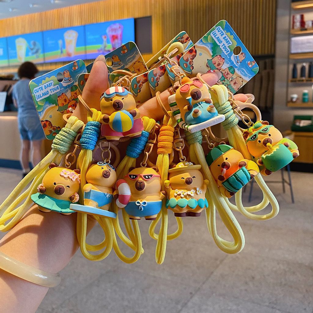 Cute capybara island vacation keychain charms showing all eight designs