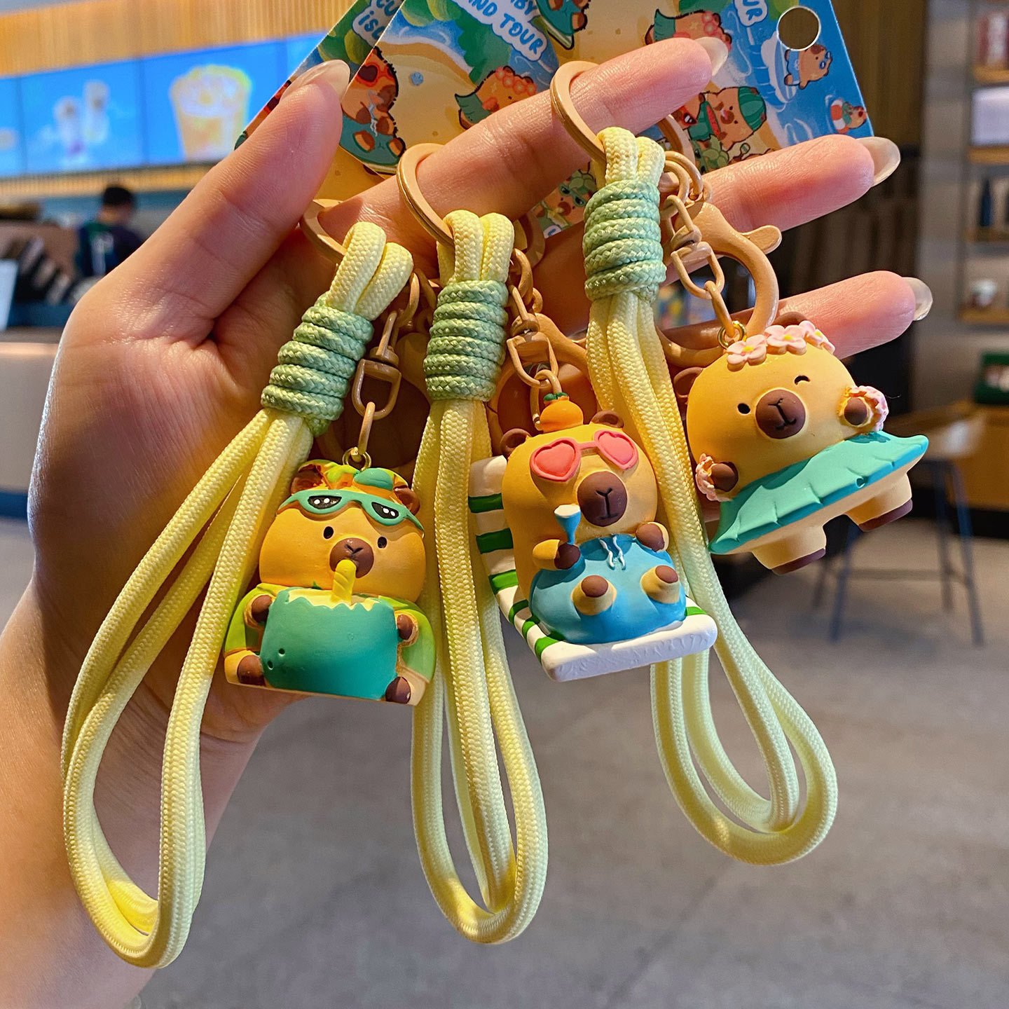Cute capybara island tour keychain charms showing multiple designs