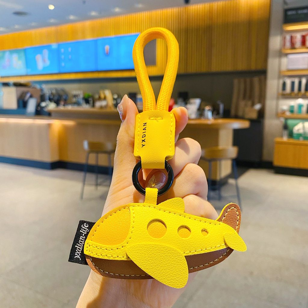 Faux leather vehicle keychain charm airplane variant