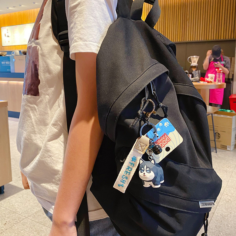 Husky keychain charm hanging on a bag