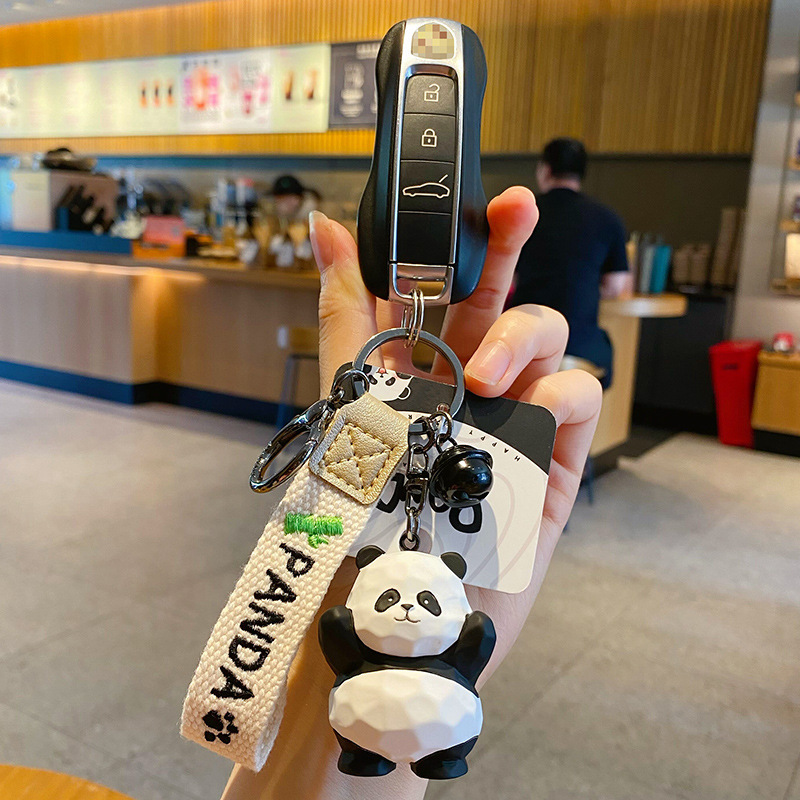 Waving panda keychain charm attached to a car key fob
