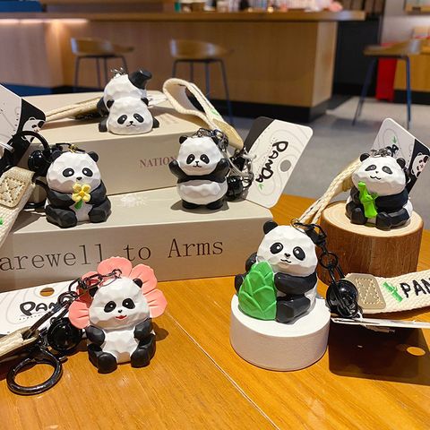 Cute panda wood carving style keychain charms showing all six designs