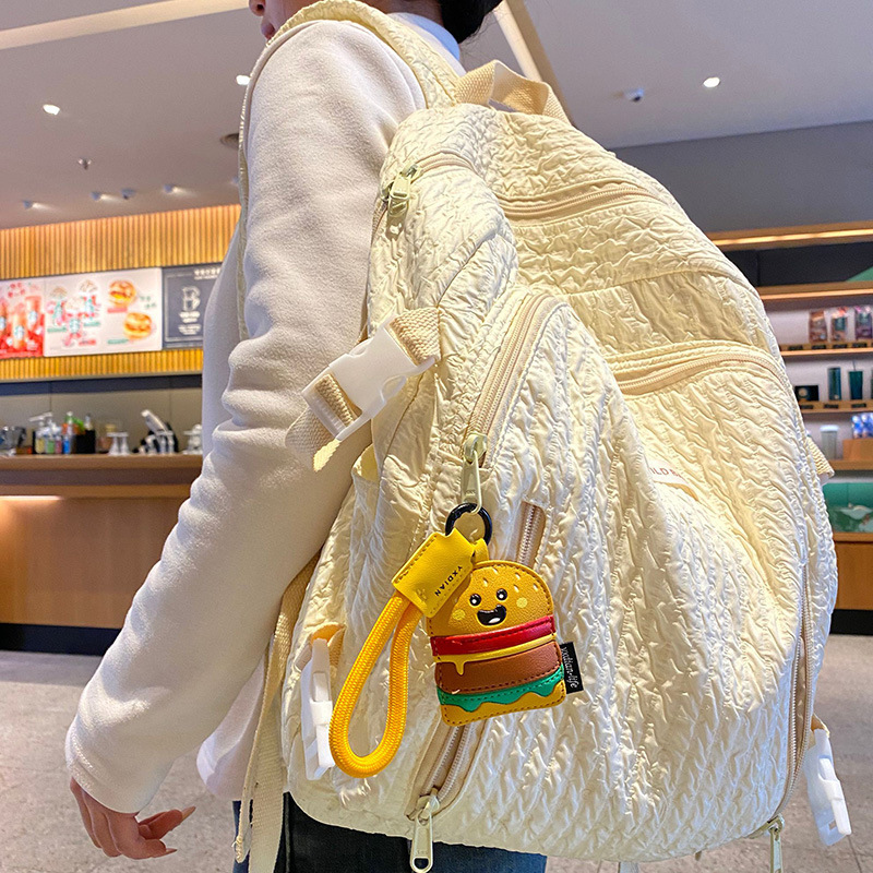 Burger keychain charm hanging on a bag