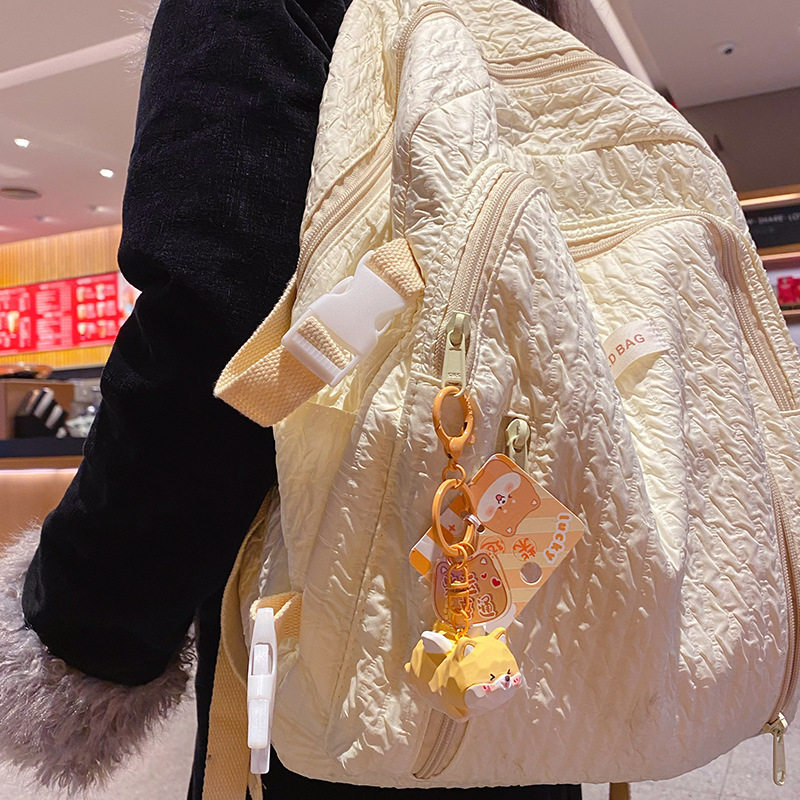 Flying Shiba Inu keychain charm hanging on a bag