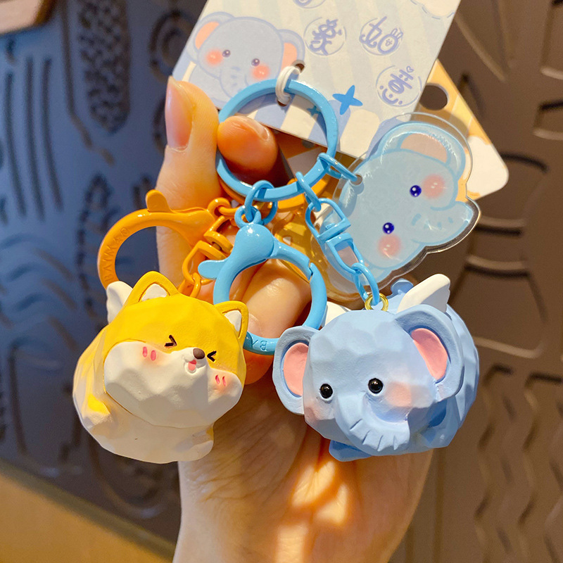 Flying Shiba Inu and flying elephant keychain charms