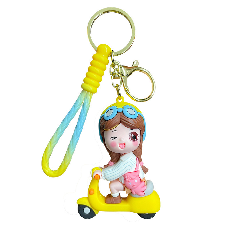 Electric scooter girl keychain charm in yellow on white background