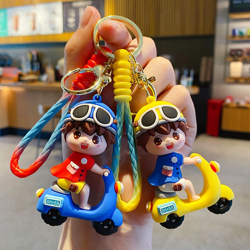 Electric scooter boy keychain charms in blue and yellow